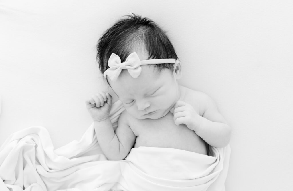 Tampa newborn photographer sharing the honest differences between studio and in-home sessions and why studio photography creates timeless, stress-free results.