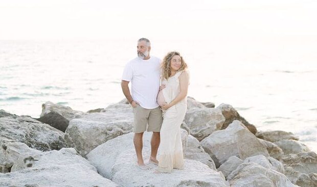st-pete-beach-maternity-session-rocks-couple.jpg