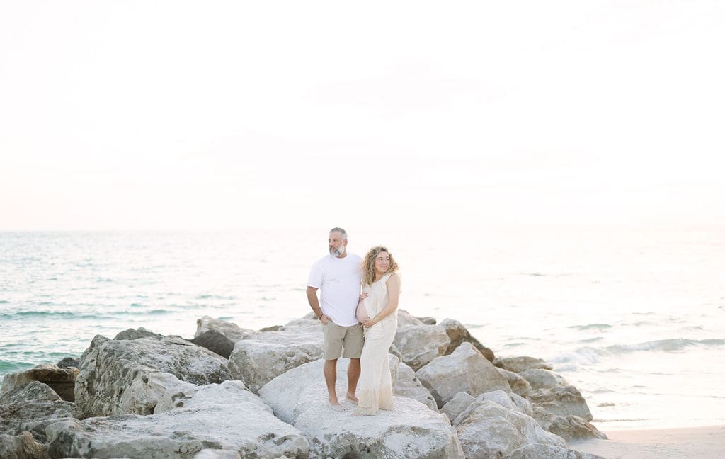 st-pete-beach-maternity-session-rocks-couple.jpg